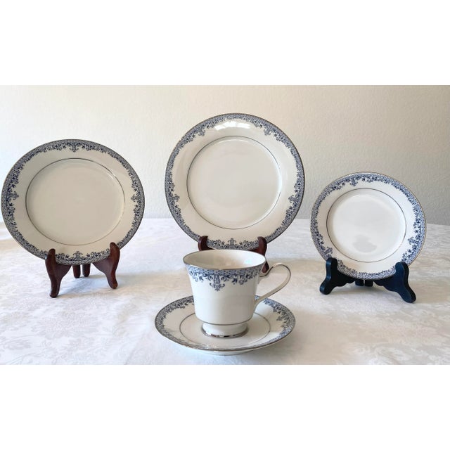 Late 20th Century Exquisite Noritake Charleston, Blue Filigree Leaves with Platinum Trim on light Ivory China. There are...
