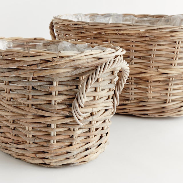 Woven by hand in a thick Kubu rattan that is claydyed & dried in the sun, these sturdy oval planters are the epitome of...