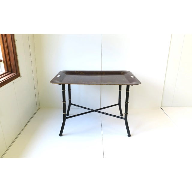 An Italian tray table cocktail table with a Chinoiserie tole tray top and black faux bamboo base, in the Regency design...
