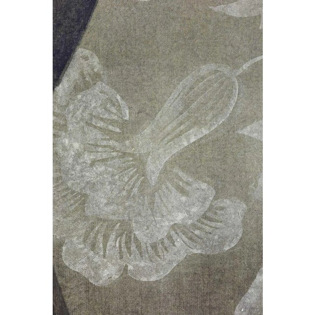 Painted canvas figuring a profile view of a man in the style of the first Italian Renaissance. The man is wearing a bonnet...