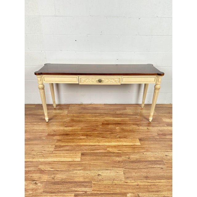 Louis XVI style console table by Henredon, medium finish banded walnut top, 1 drawer and a cream painted base with...