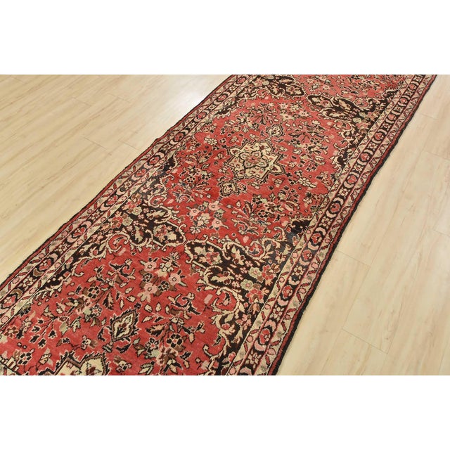 An authentic semi-antique, traditional Malayer runner hand-knotted with fine wool and natural dyes. This oriental rug...
