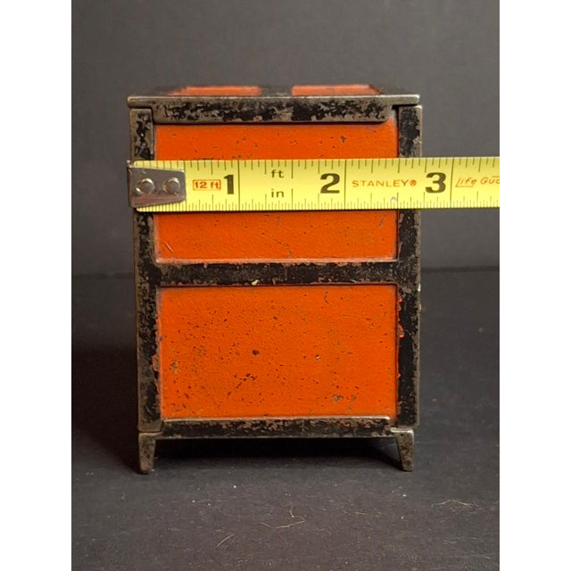 Historical Provenance & Design Significance This late-19th-century American miniature safe bank represents a pinnacle of...