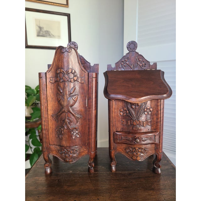 Charming pair of late 19th century French Provincial salt & flour boxes. Both raised on cabriole legs with hoof feet. The...