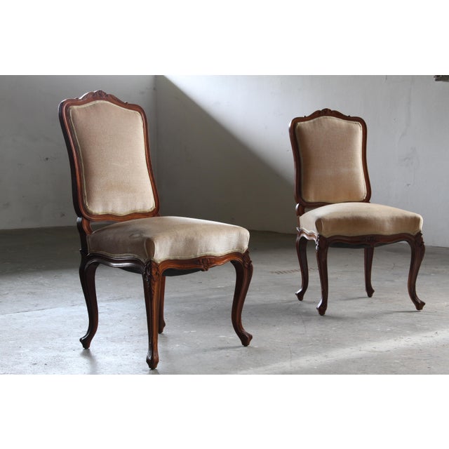 This elegant pair of hand-carved and decorated wooden rococo Lounge Chair from the mid-18th century embody that timeless...