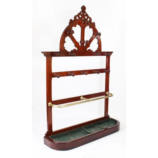 This is a large antique victorian hall umbrella, hat and coat stand, circa 1860 in date. The hall stand is made of solid...