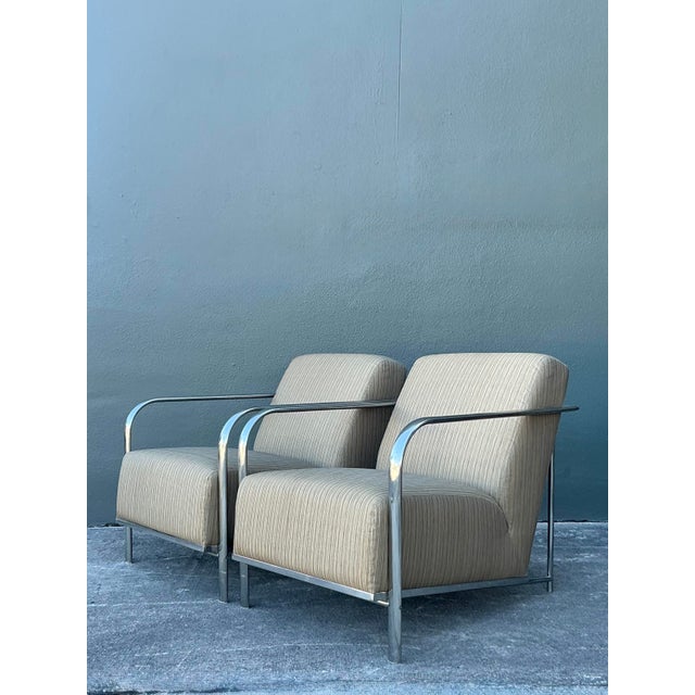 This striking pair of vintage lounge chairs captures the sleek, architectural spirit of Postmodern and Mid-Century Modern...