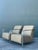 This striking pair of vintage lounge chairs captures the sleek, architectural spirit of Postmodern and Mid-Century Modern...