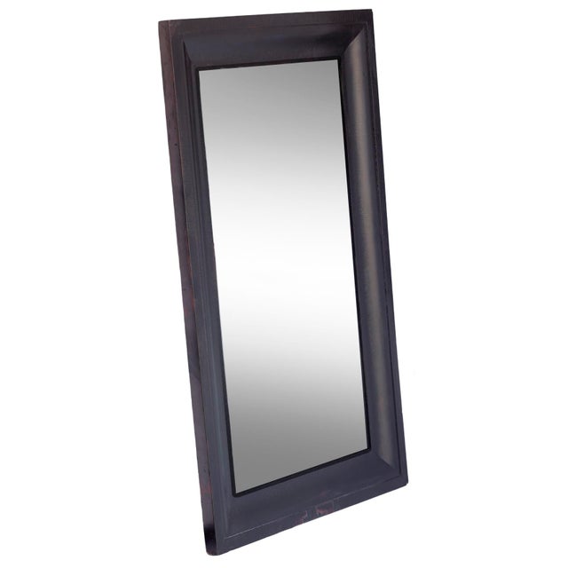 American Empire mahogany veneered mirror in ebony with original wood backing. The frame curves inward toward the mirrored...