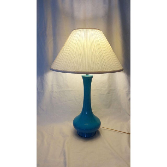 Mid-Century vibrant sky blue/azure blue ceramic lamp with a crackle glaze finish. The "Genie Bottle" shaped table lamp has...