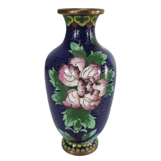 This vintage Chinese cloisonné vase is a stunning decorative piece. It features intricate lotus and vine floral designs in...