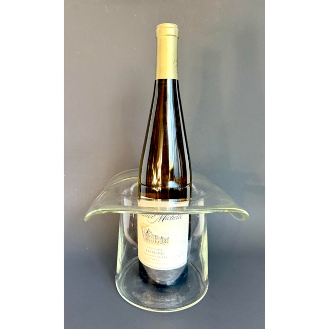 Here is a sculptural mid-century glass ice bucket or wine chiller designed in the form of a top hat, featuring a...