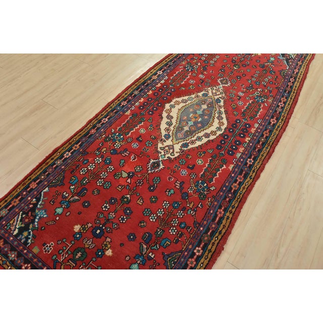 An authentic vintage tribal Malayer runner hand-knotted with fine wool and natural dyes. This oriental rug features a...
