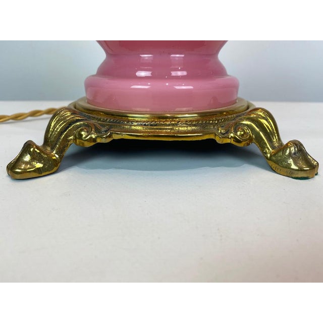 Table lamp with frame of pink opaline glass and shade of white opaline glass, and foot of brass, by Funen's glassworks...