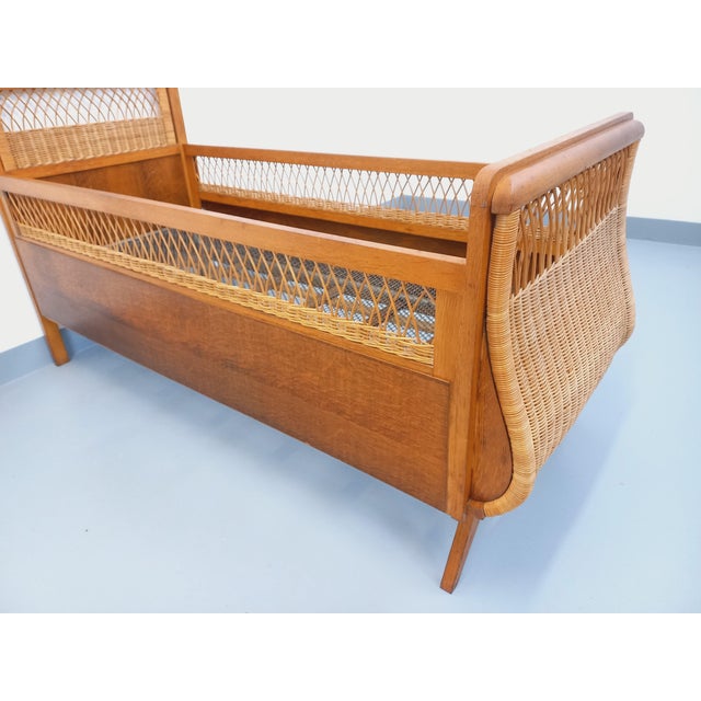 Vintage 1960s baby or toddler bed, cute and charming style, made of oak and rattan, with a metal mesh base. In good...