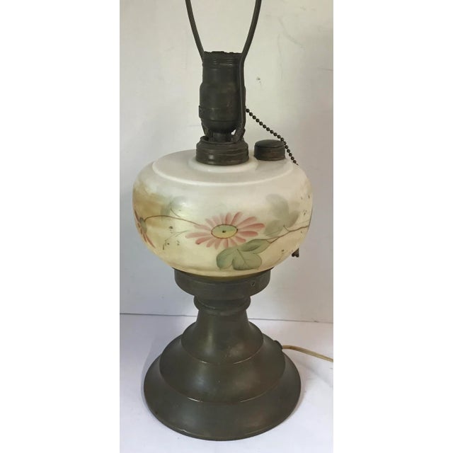Vintage brass and hand painted oil lamp that was converted to electric. Works, but has not been rewired. Pretty!
