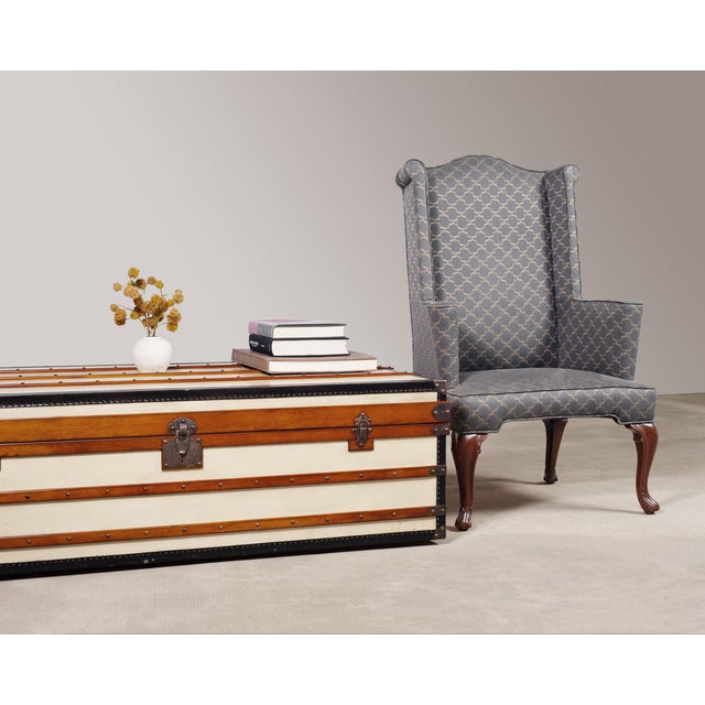 A handsome Campaign-style steamer trunk or coffee table executed in ivory canvas panels, honey-toned hardwood battens, and...