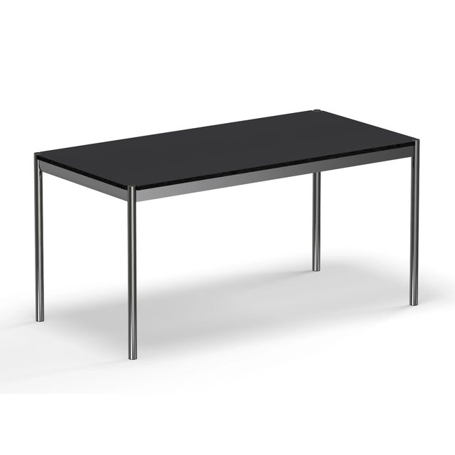 Brand new! A modern office table with a chrome frame and table legs and a black linoleum top. Designed by Swiss architect...