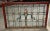 C. 1905 Beaux Arts style leaded polychrome stained and textured glass window panel having geometric patterned centered...