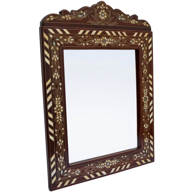 Gorgeous vintage Syrian mirror thoughtfully handcrafted exhibiting an ornate hand-carved solid walnut wood with remarkable...