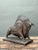 This mid-century plaster sculpture captures a bull in dynamic motion, its muscular build, arched hump, and braced legs...