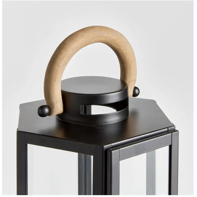 The Small Dockside Outdoor Lantern Size: 9 x 8 x 23 This matte black six panel lantern is made of iron and features a...