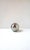 A chrome plated brass sphere decorative object, in the Modern style/Postmodern period, circa late-20th century. Piece is...