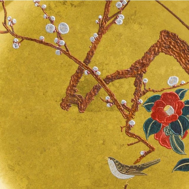 This handcrafted decorative plate, titled “Plum, Camellia & Japanese Bush Warbler,” depicts an elegant Japanese landscape...