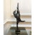 A contemporary figurative bronze of a woman caught mid-leap, body stretched into a single soaring diagonal — legs flung...