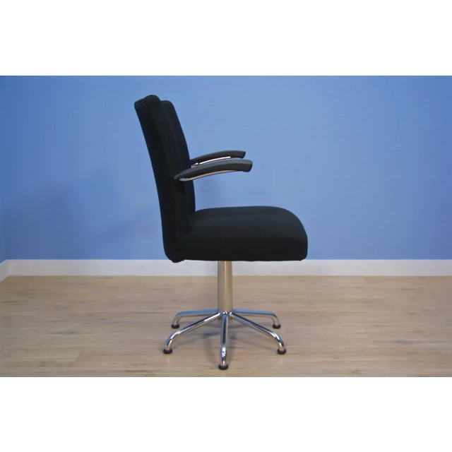 The armrests of this chair are upholstered with black leatherette. I have official proof of authenticity such as vintage...