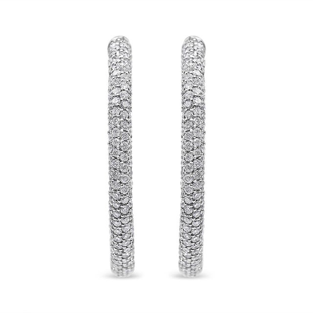 A dewy oval silhouette drips with French pavÃ©-set diamonds giving these 18k white gold hoop earrings a dazzling modern...