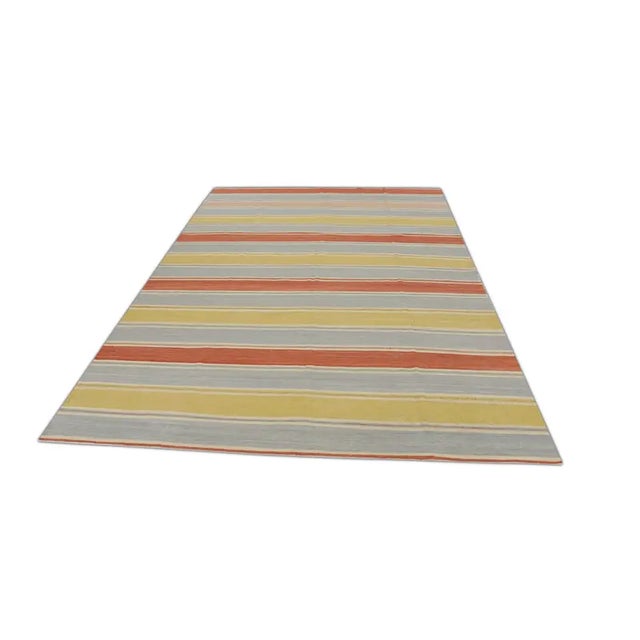 This early 21st-century Turkish flatweave Kilim rug, measuring 8'10" X 12'2", is a stunning example of traditional...