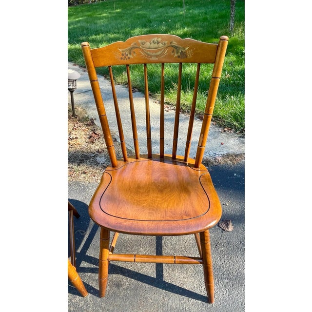 Offered are two L. Hitchcock country side chairs in the harvest finish with a fruit bowl hand stenciled pattern. The...