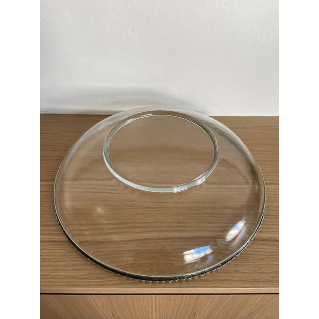 This Arte Italica shallow bowl is made with mouth-blown glass accented with an extraordinary pewter beaded rim that blends...