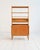 Oak bookcase featuring a storage unit with sliding doors and an open upper structure with adjustable shelves. Designed by...