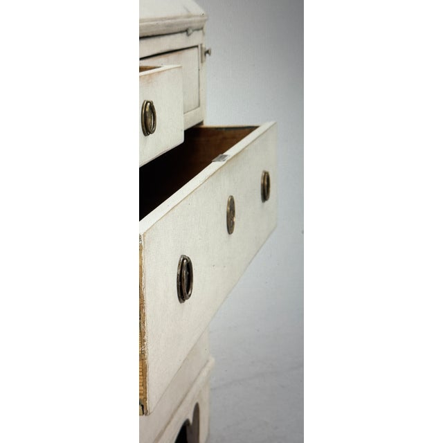 A stunning 19th-century bureau with a light-colored frame and dark interior. It consists of two parts. It features a...