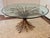 Sculptural Italian Hollywood Regency coffee table featuring an intricately detailed gilt metal wheat sheaf base with rope...