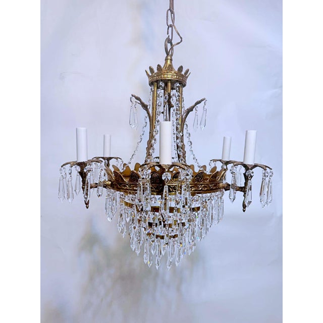 Restored empire style chandelier with brass frame, a-chain crystals and 30% leaded plug crystals. It has 9 candelabra base...