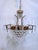 Restored empire style chandelier with brass frame, a-chain crystals and 30% leaded plug crystals. It has 9 candelabra base...