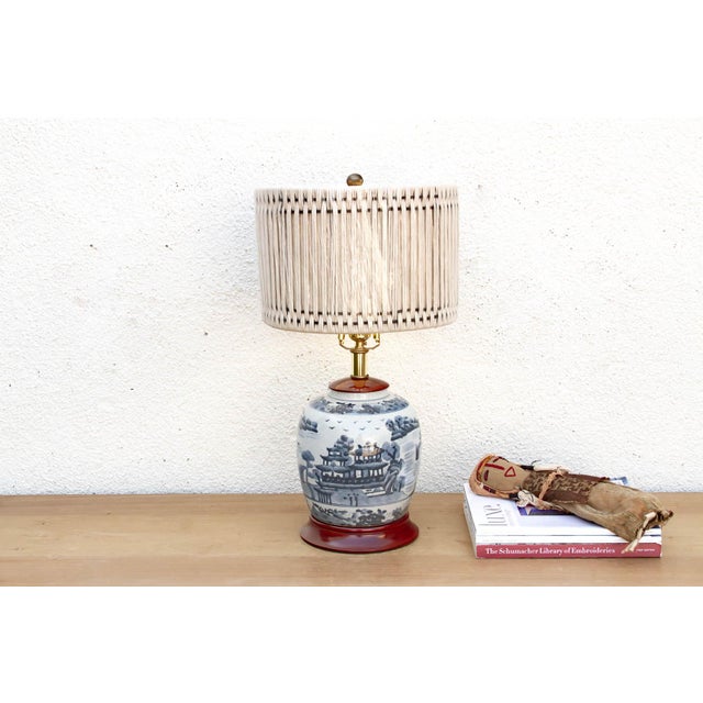 This exceptional table lamp is crafted from a vintage porcelain ginger jar, featuring a rare and intricate panoramic...