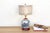 This exceptional table lamp is crafted from a vintage porcelain ginger jar, featuring a rare and intricate panoramic...