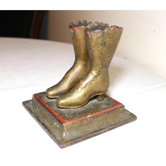 Up for sale is a very rare antique late 19th century pair of figural cast iron boots match holder. It can also be used as...