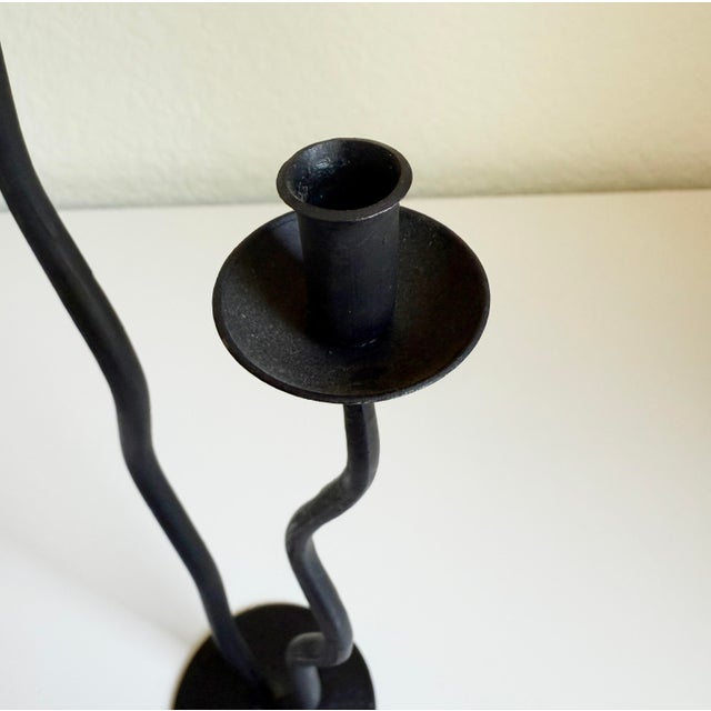 Vintage 1980s hand forged iron candle holder featuring double arms with squiggle design. A highly sculptural piece with...