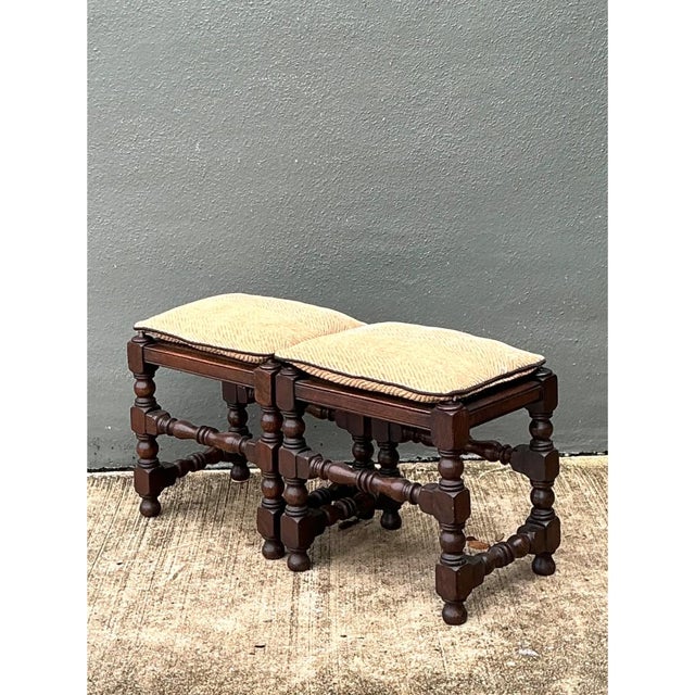 This pair of vintage low stools showcases finely turned wood legs in a classic Jacobean-inspired silhouette, each leg...