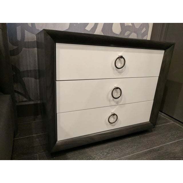 Ash wood with a graphite finish on the frame and off-white finish on the drawers, with polished nickel pull rings and a...