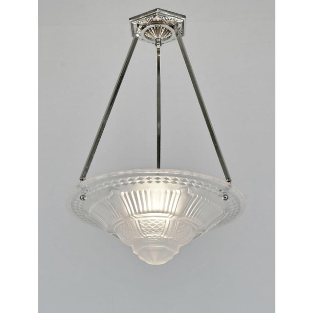 Muller frères A nickel-plated bronze or solid brass French art deco pendant made around 1930. It holds a signed bowl by...