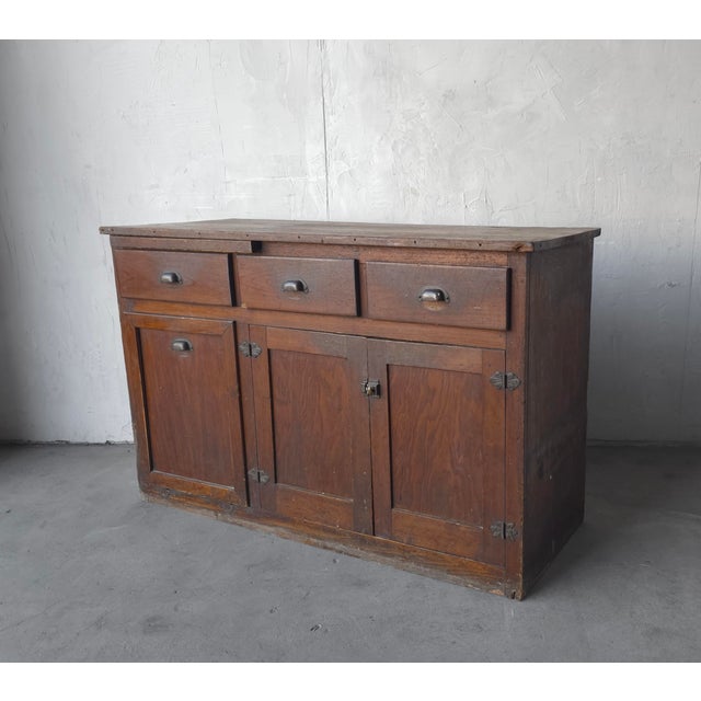 A sideboard is a beautiful example of antique cabinetry. With a pull out cutting board and functioning grain bin, this...
