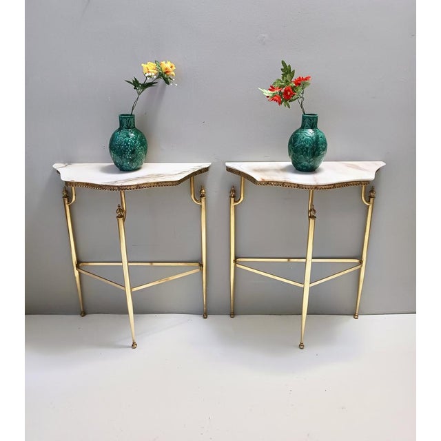Made in Italy, 1950s. This console table features a Portuguese pink marble top and a brass frame. It is a vintage item,...