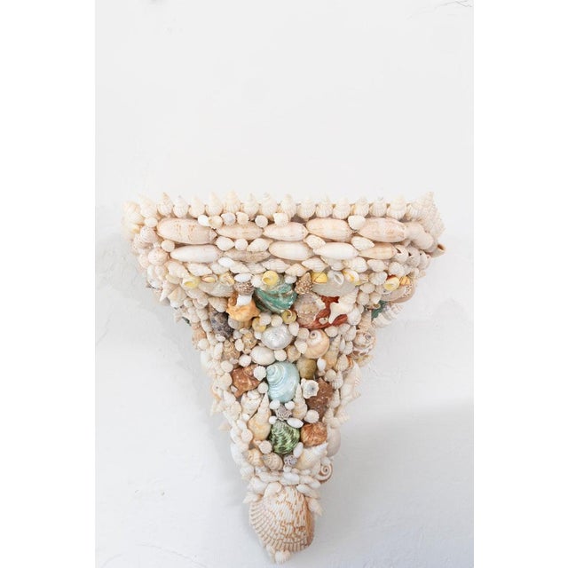 This is a whimsical pair of handcrafted wall brackets lavishly encrusted with an extraordinary assortment of natural...