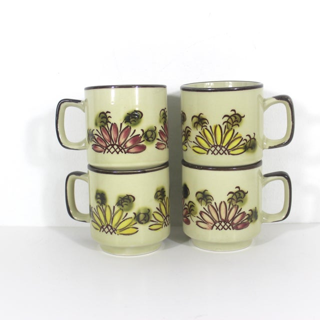 Elevate your morning cup with this set of four unique, Japanese vintage pottery mugs. This set truly charming with their...